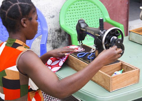 A student at the sewing school working at a vintage sewing machine